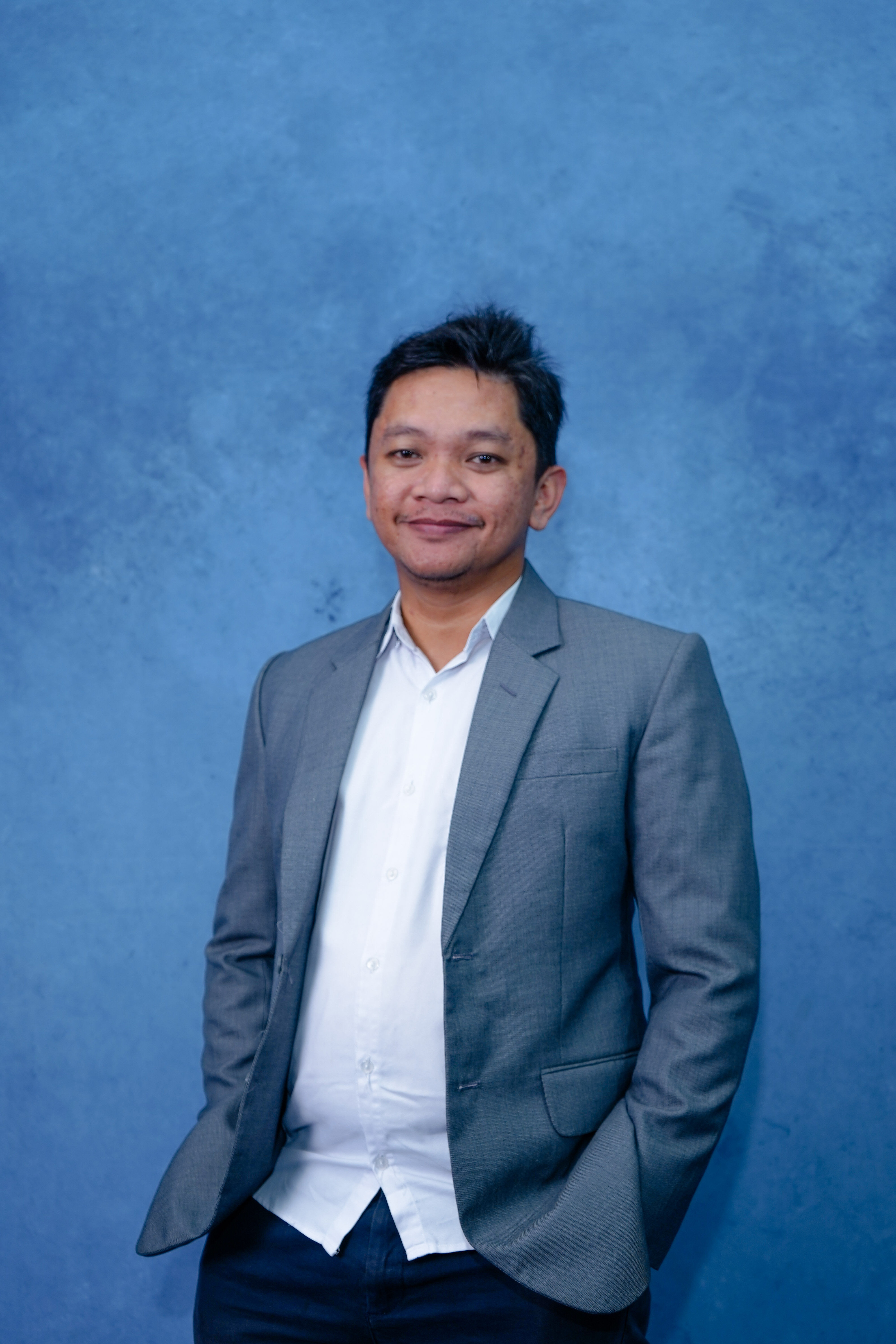 Professional headshot of Anna Garcia, mobile app developer with smartphone and laptop, confident pose, modern office environment, tech-savvy appearance